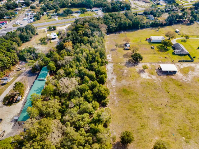 an aerial view of residential houses with outdoor space