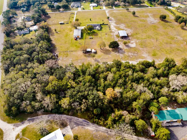 an aerial view of residential houses with swimming pool and outdoor space