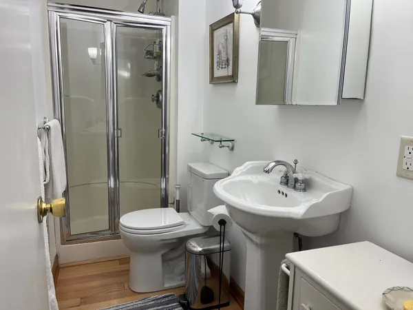 a bathroom with a sink toilet and shower