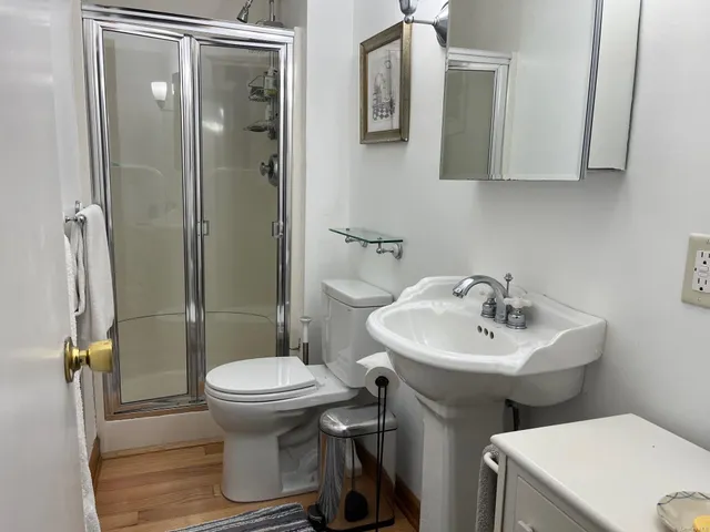 a bathroom with a sink toilet and shower