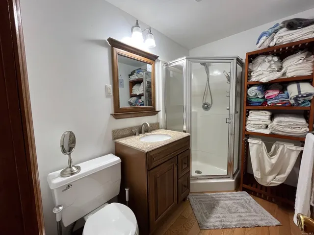 a bathroom with a toilet a sink and mirror