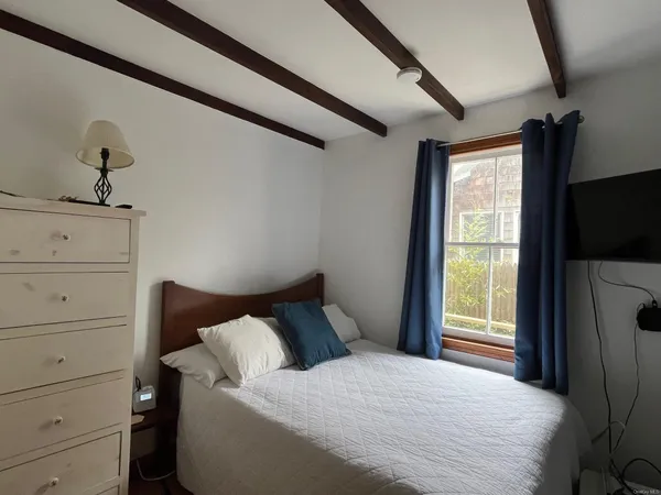a bedroom with a bed and a flat tv screen