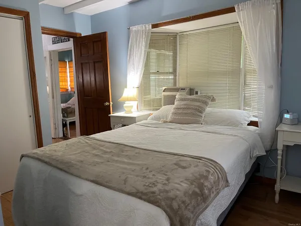 a bedroom with a bed and a large mirror