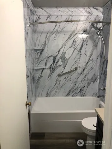 a bathroom with a toilet and a bathtub