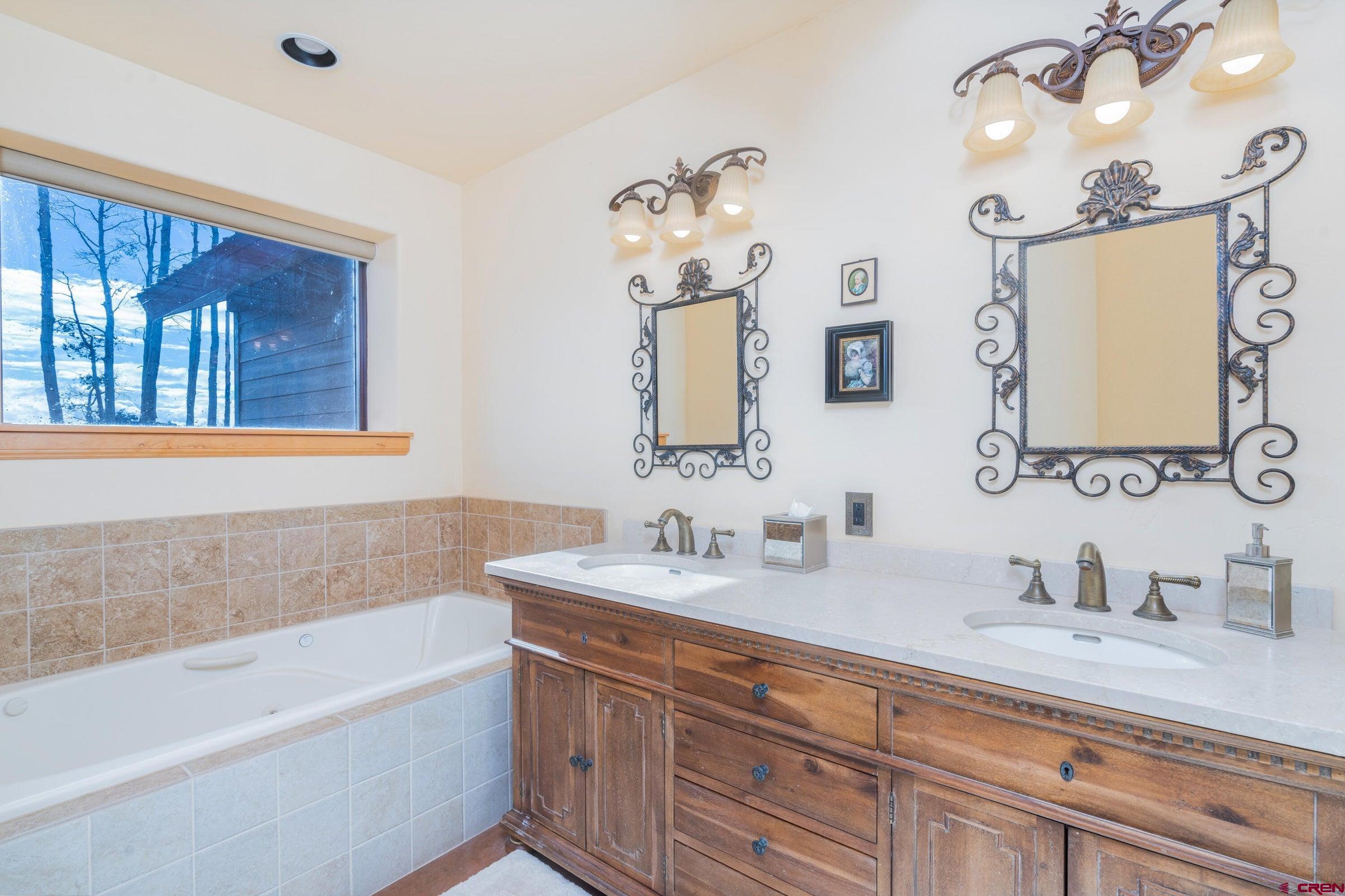 9949-county Rd 58p Placerville, CO 81430 - Photo 11 of 23 a bathroom with a tub sink and mirror