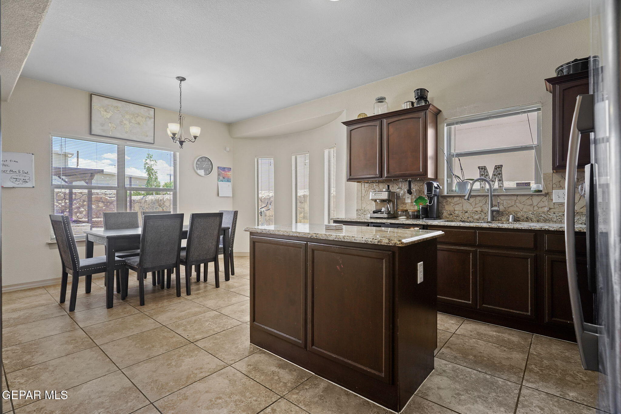 3152 Rustic Hidden Drive El Paso, TX 79938 - Photo 11 of 38 a kitchen with granite countertop a sink counter top space appliances and cabinets