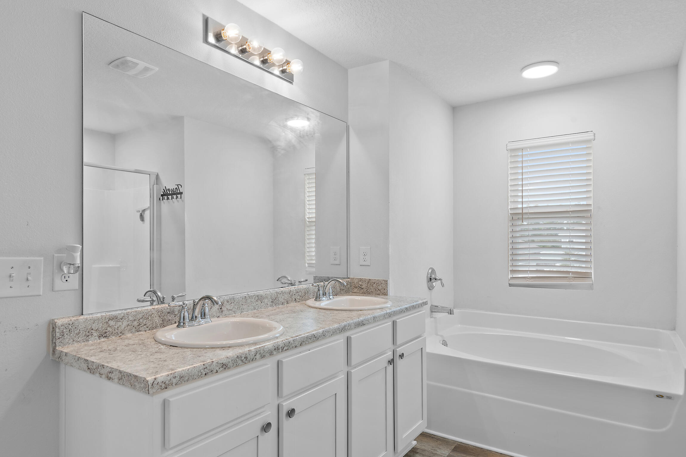 258 This Way, Unit LOT 79 Freeport, FL 32439 - Photo 22 of 80 a bathroom with a sink double vanity granite tub and a mirror