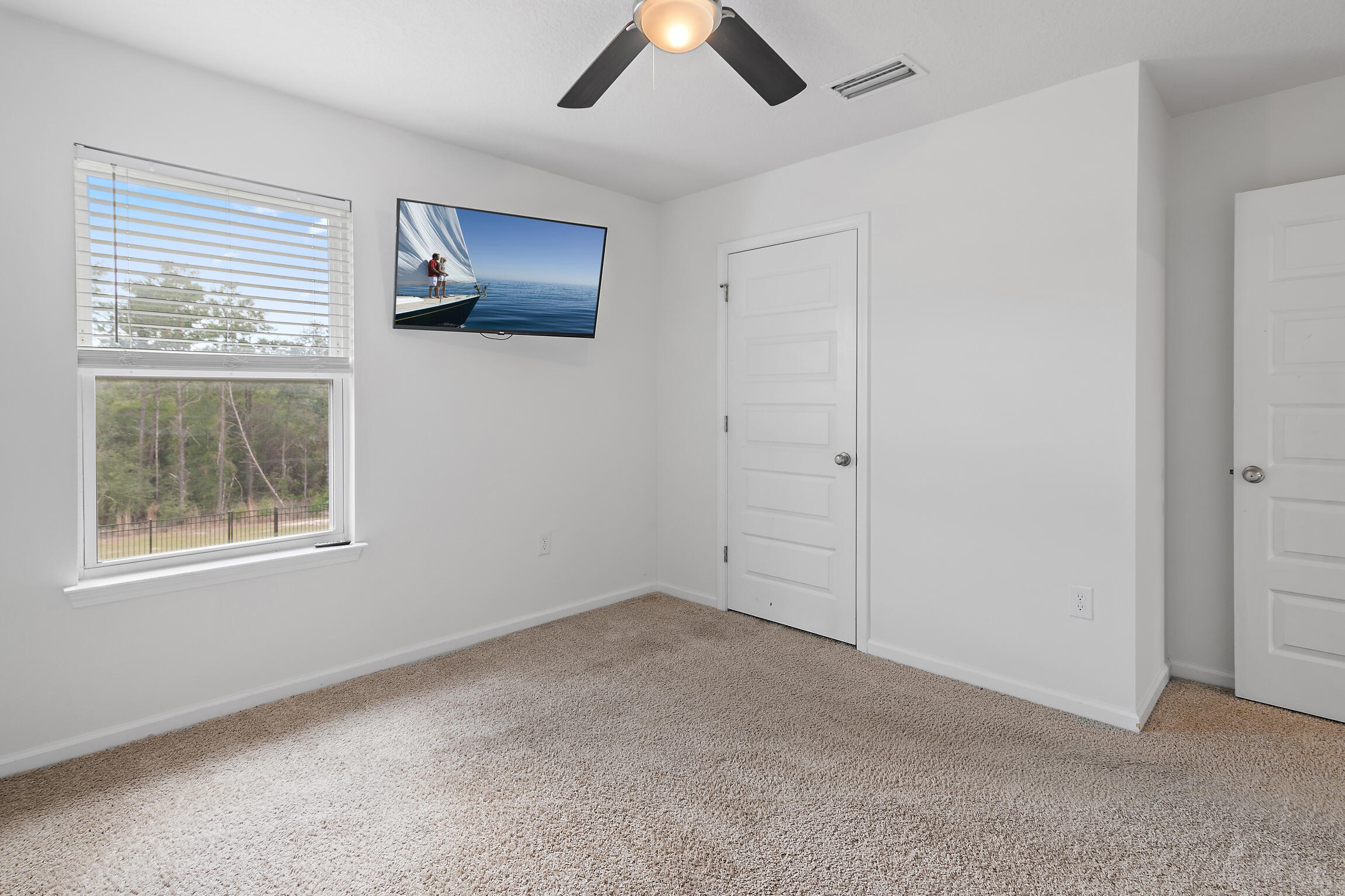 258 This Way, Unit LOT 79 Freeport, FL 32439 - Photo 28 of 80 an empty room with chandelier fan and windows