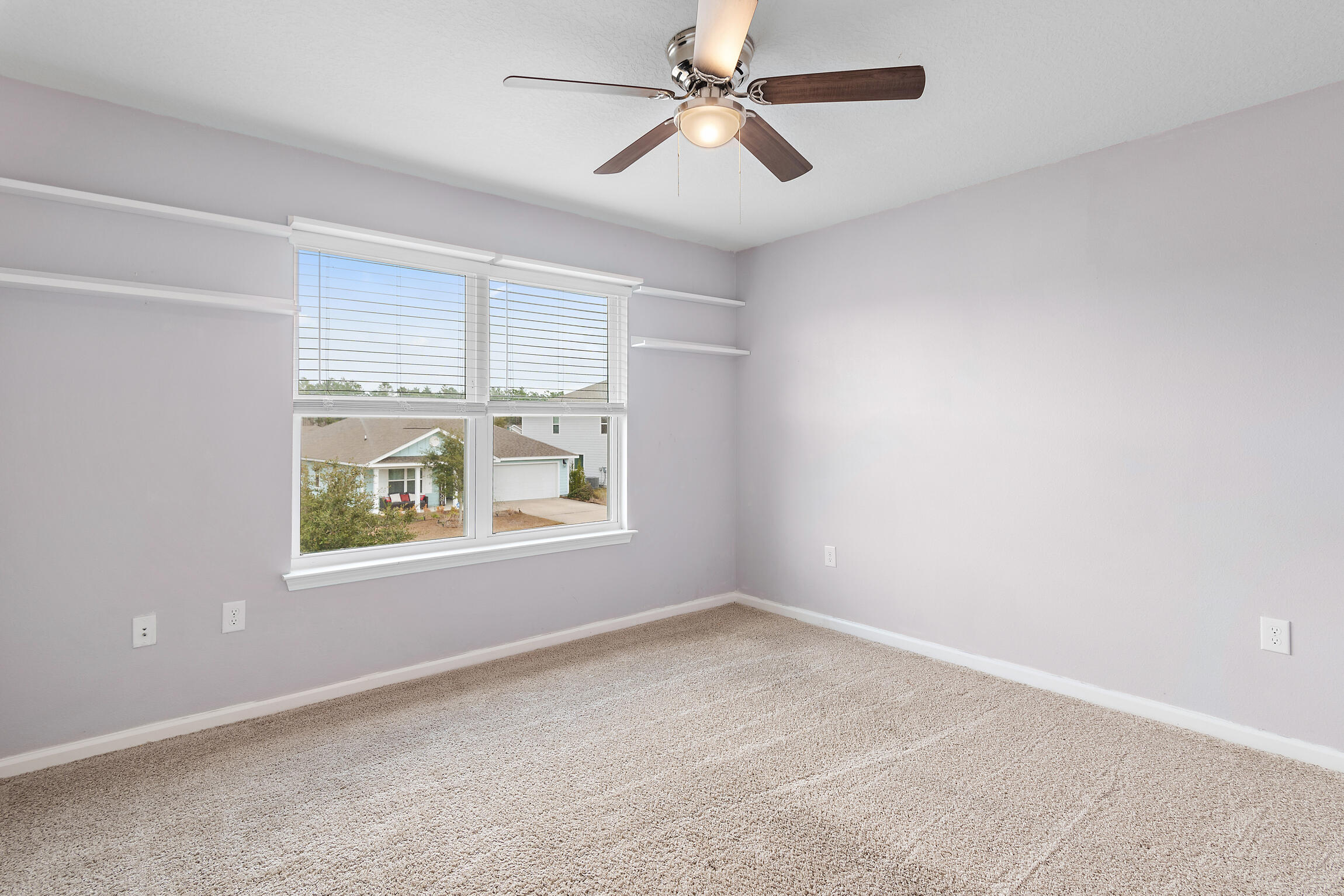 258 This Way, Unit LOT 79 Freeport, FL 32439 - Photo 31 of 80 an empty room with windows and ceiling fan