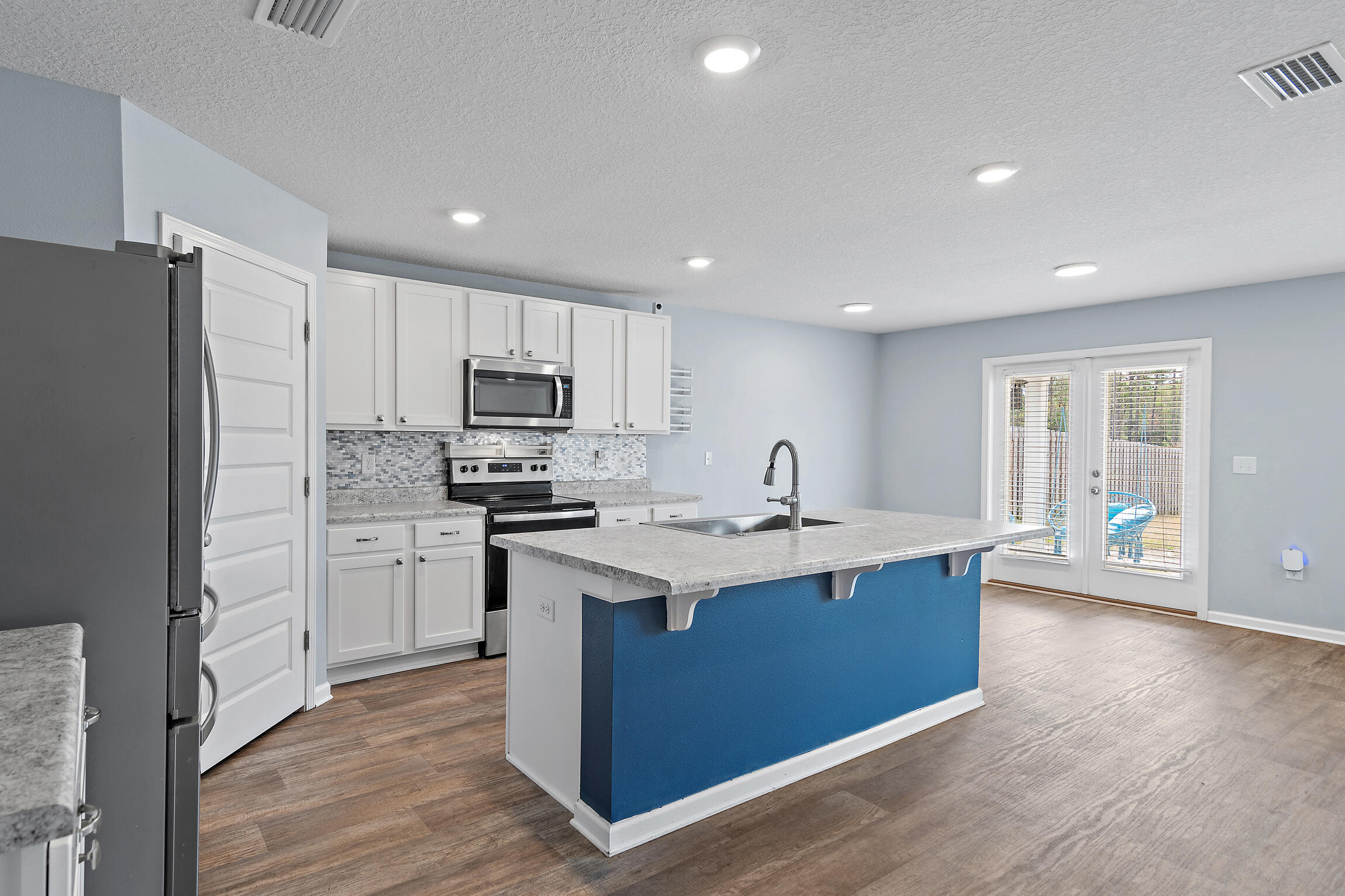 258 This Way, Unit LOT 79 Freeport, FL 32439 - Photo 5 of 80 a kitchen with stainless steel appliances granite countertop a sink stove and refrigerator