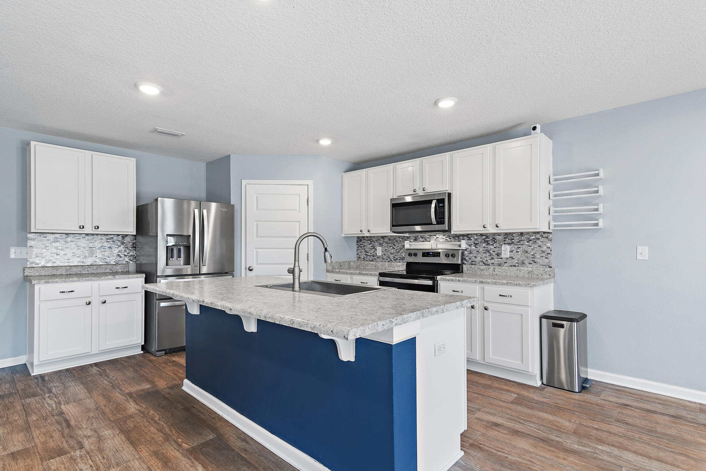258 This Way, Unit LOT 79 Freeport, FL 32439 - Photo 6 of 80 a kitchen with stainless steel appliances granite countertop a sink stove microwave and refrigerator