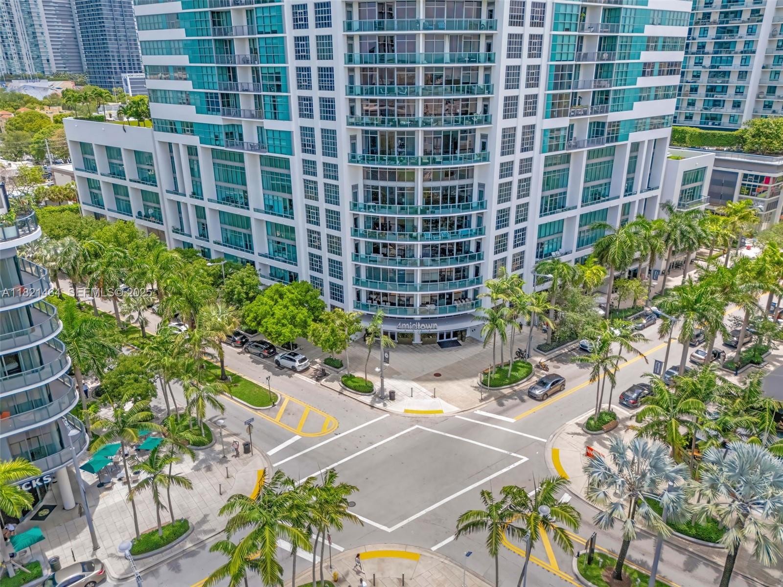 Midtown Miami Miami, FL 33137 - Photo 13 of 17 a view of a balcony with a table and chairs and potted plants