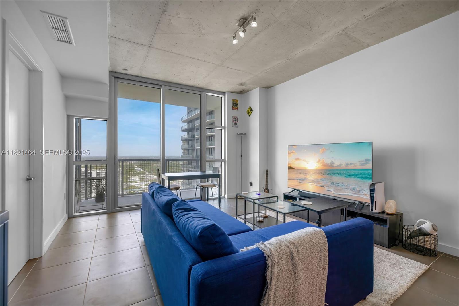 Midtown Miami Miami, FL 33137 - Photo 2 of 17 a living room with furniture and a flat screen tv