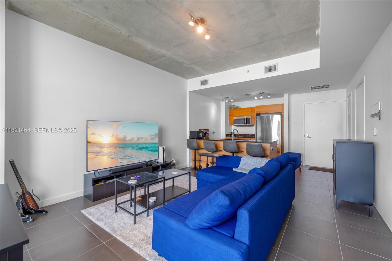 Midtown Miami Miami, FL 33137 - Photo 4 of 17 a living room with furniture and a flat screen tv