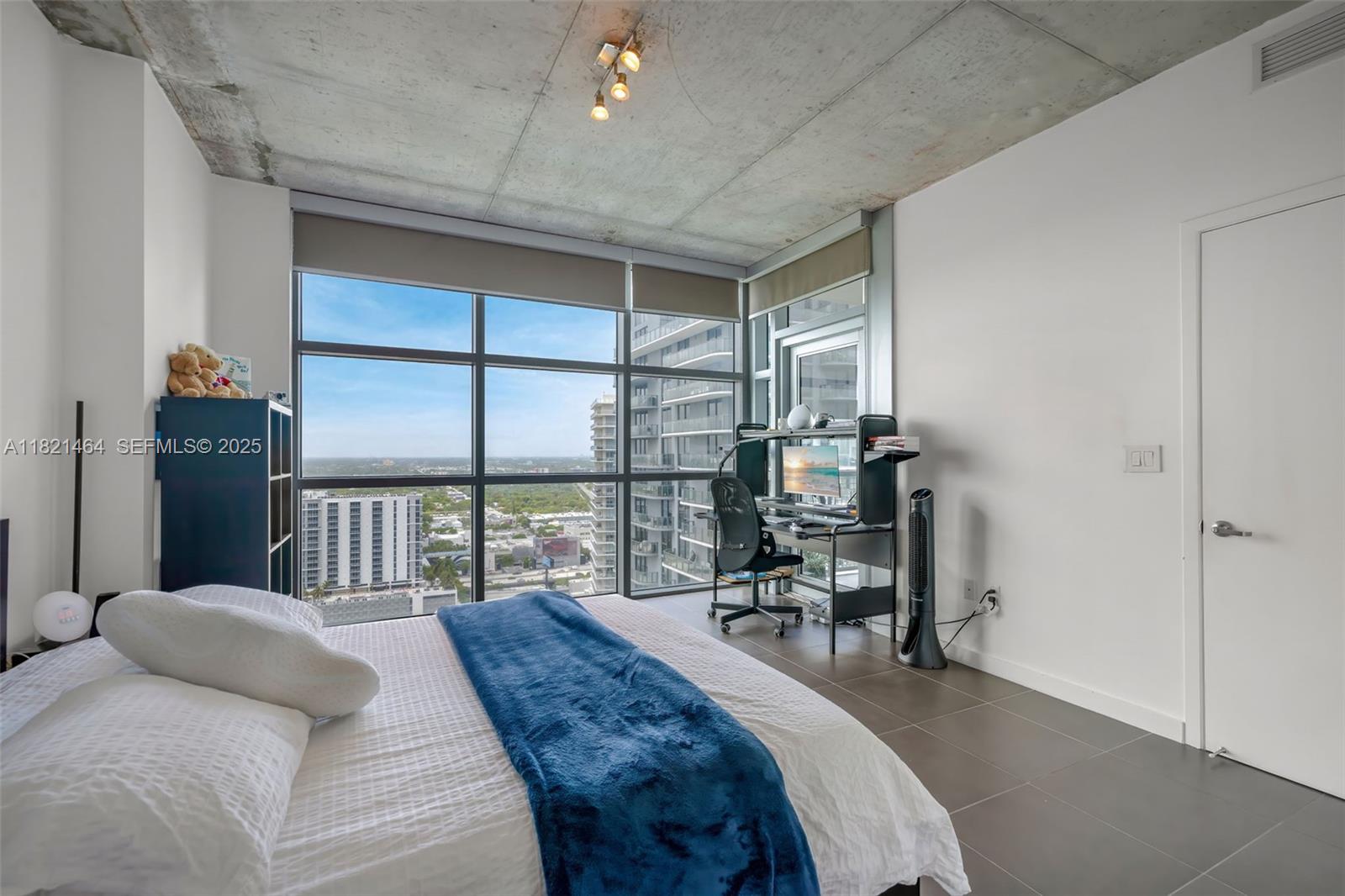 Midtown Miami Miami, FL 33137 - Photo 6 of 17 a bedroom with a bed and a large window