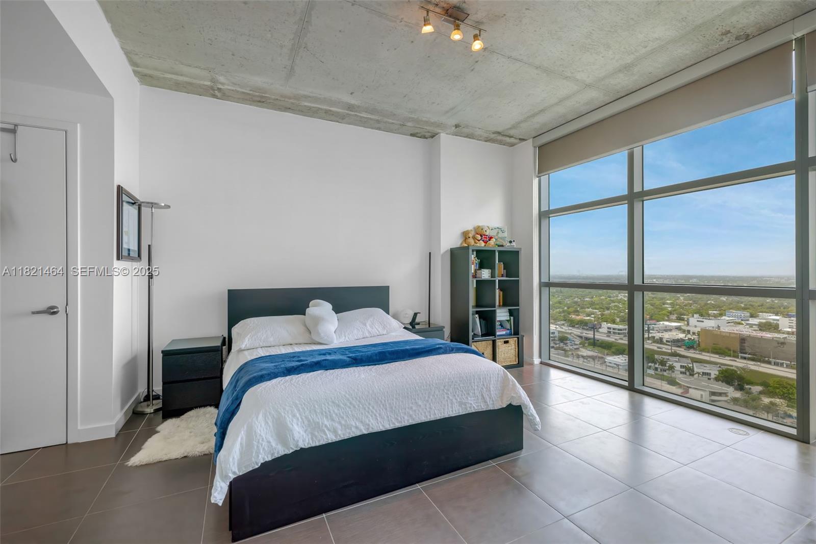 Midtown Miami Miami, FL 33137 - Photo 7 of 17 a bedroom with a large bed and a large window