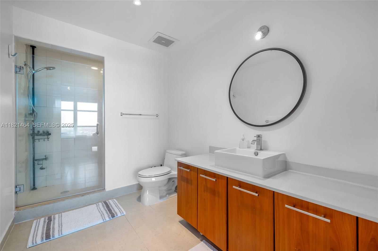 Midtown Miami Miami, FL 33137 - Photo 10 of 17 a bathroom with a toilet a sink and a mirror