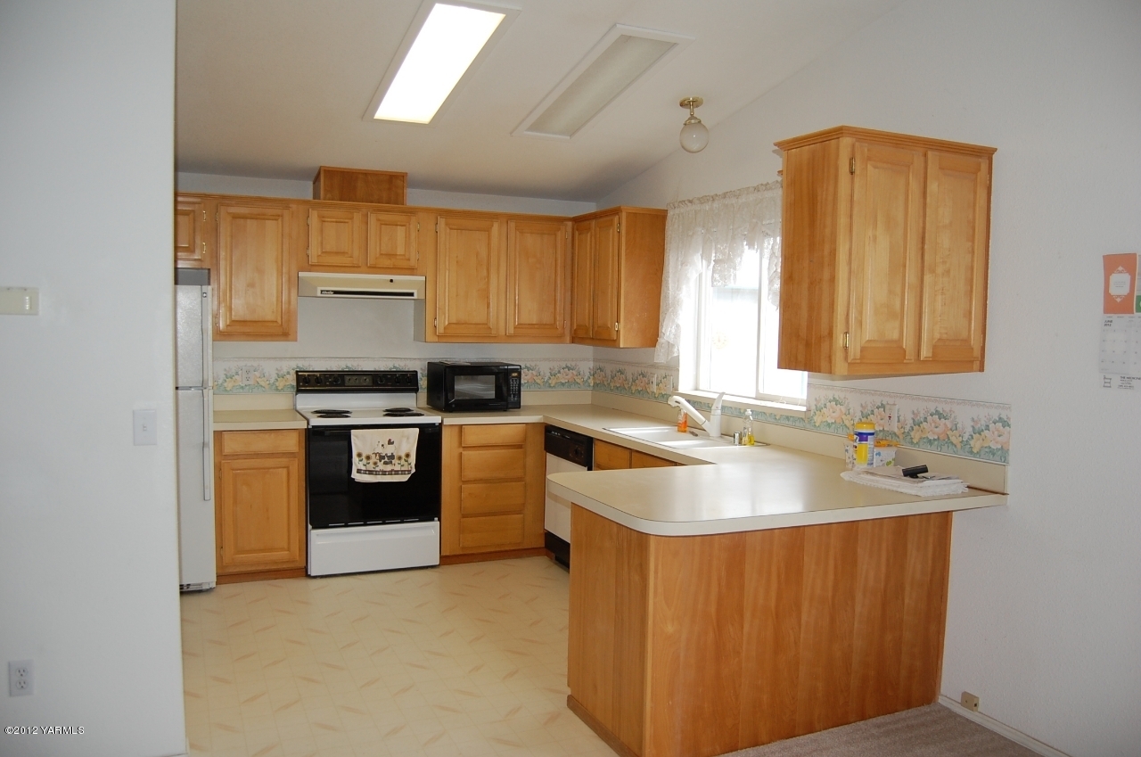 9614 Mieras Road Yakima, WA 98901 - Photo 2 of 13 a kitchen with stainless steel appliances granite countertop a sink stove and refrigerator