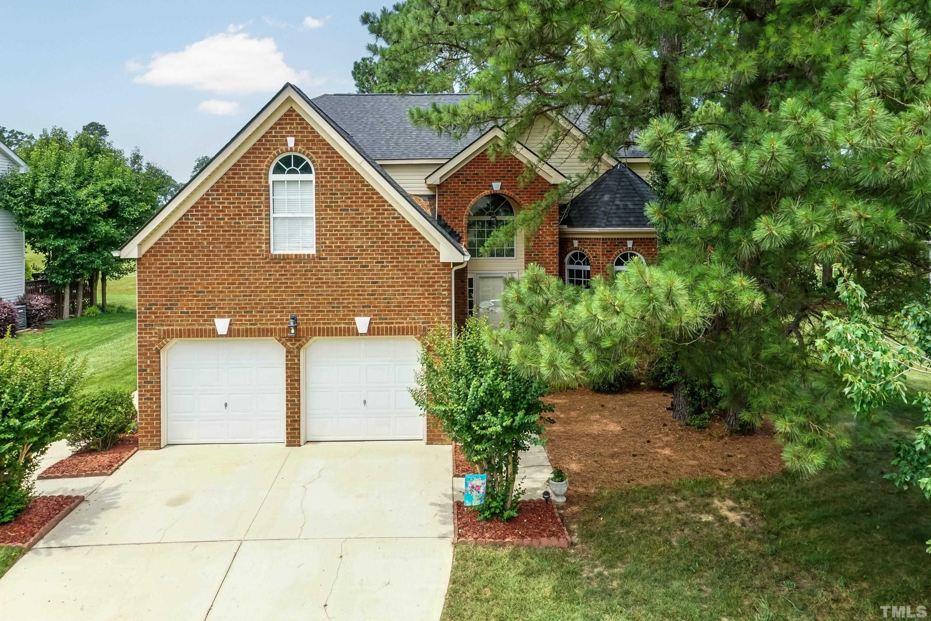 342 Seastone Street Raleigh, NC 27603 - Photo 1 of 50 a front view of a house with a yard and garage