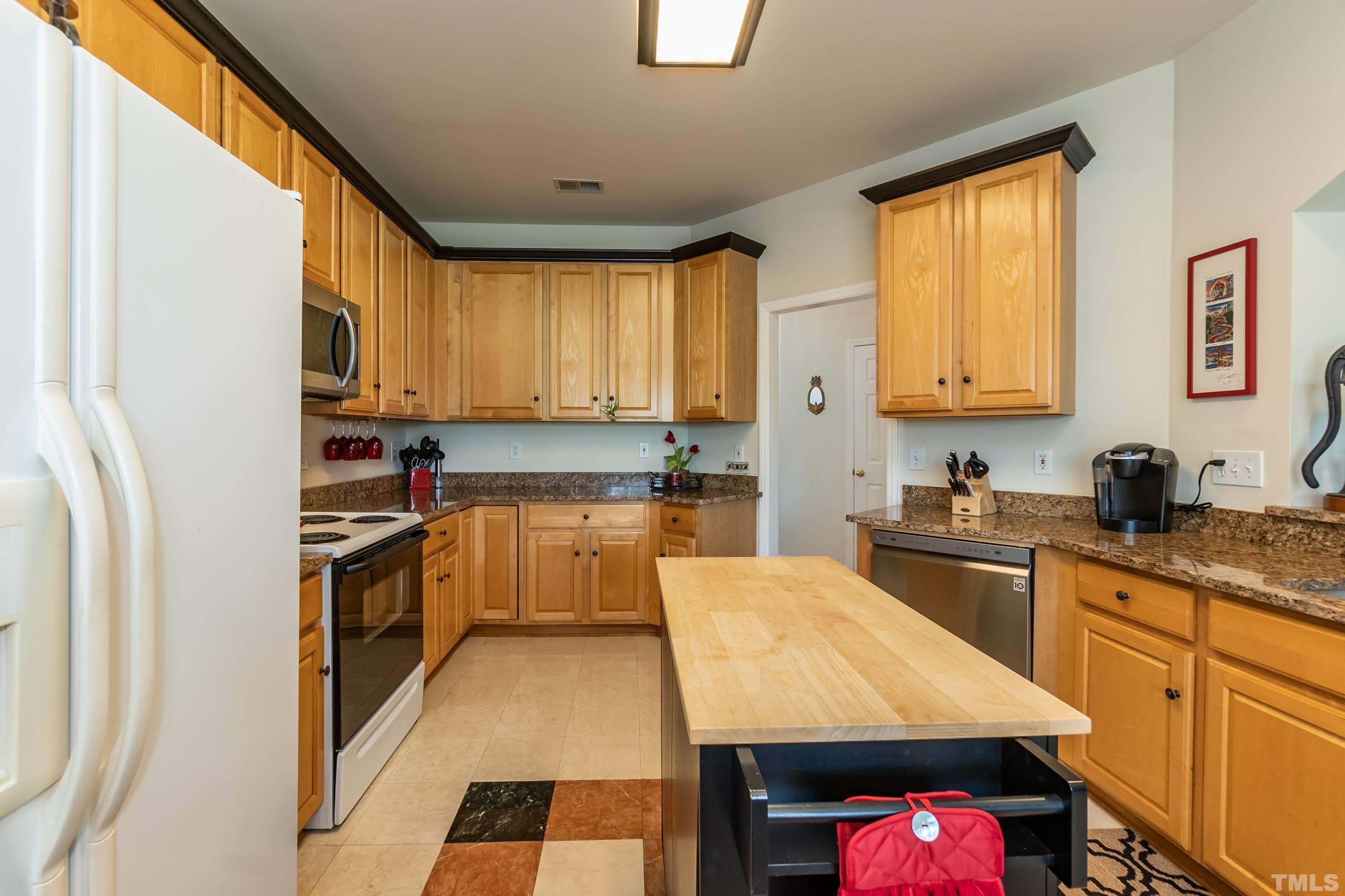 342 Seastone Street Raleigh, NC 27603 - Photo 11 of 50 a kitchen with a sink stove top oven and refrigerator