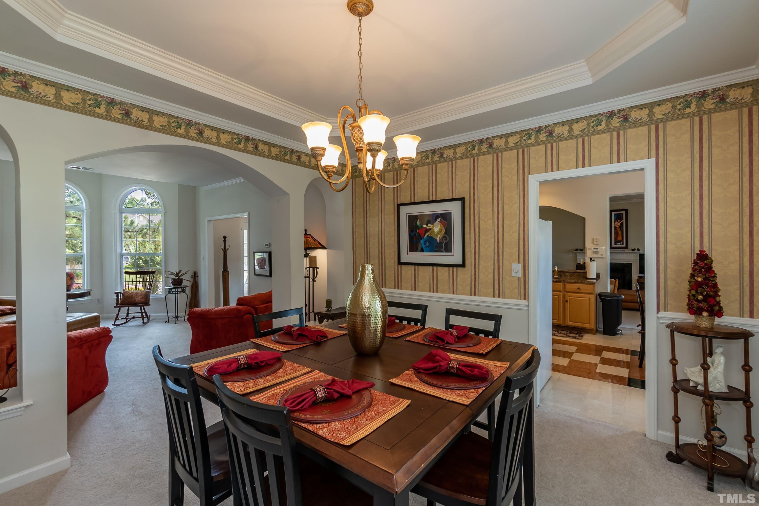 342 Seastone Street Raleigh, NC 27603 - Photo 17 of 50 a view of a dining room with furniture and a chandelier