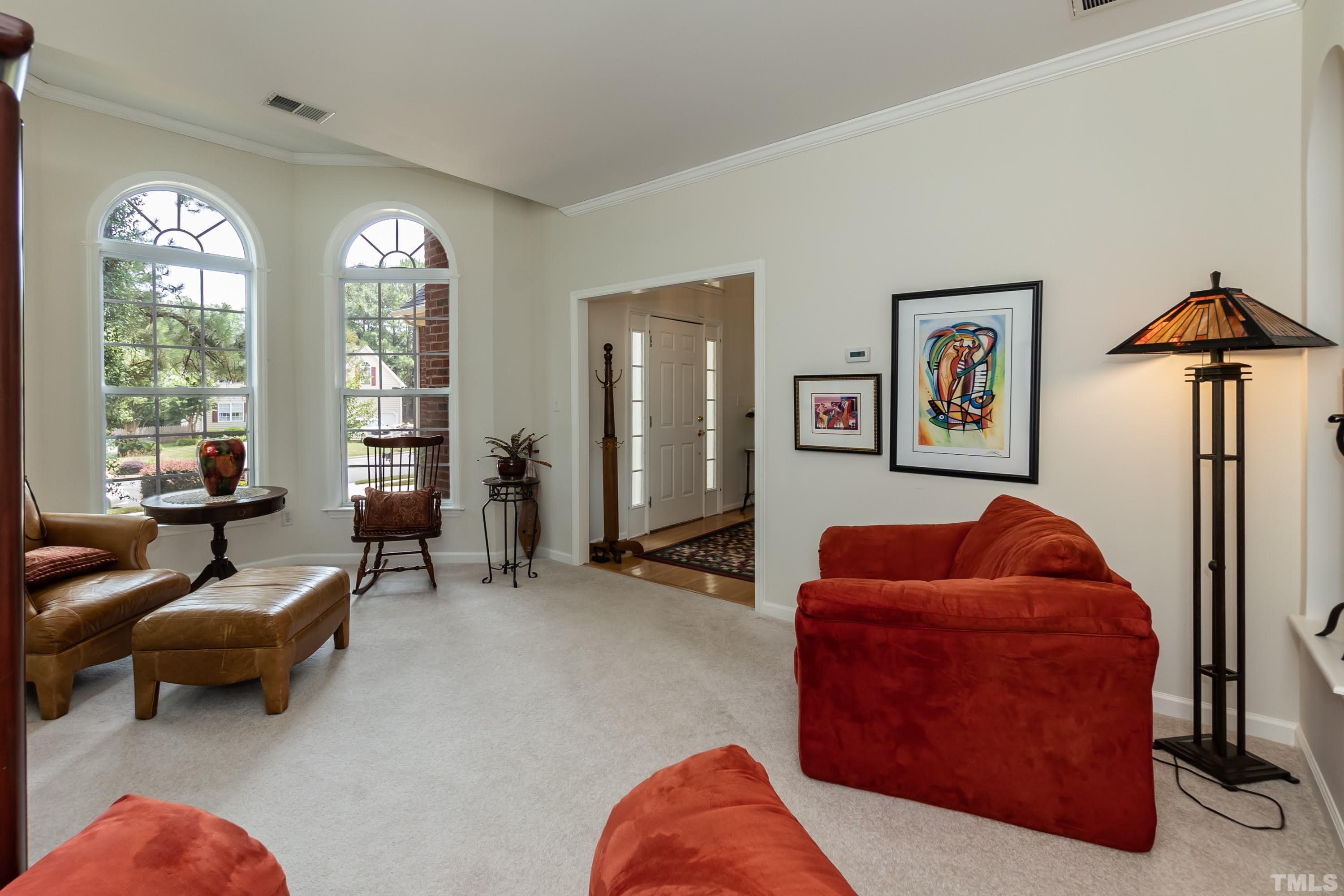 342 Seastone Street Raleigh, NC 27603 - Photo 19 of 50 a living room with furniture and a chandelier