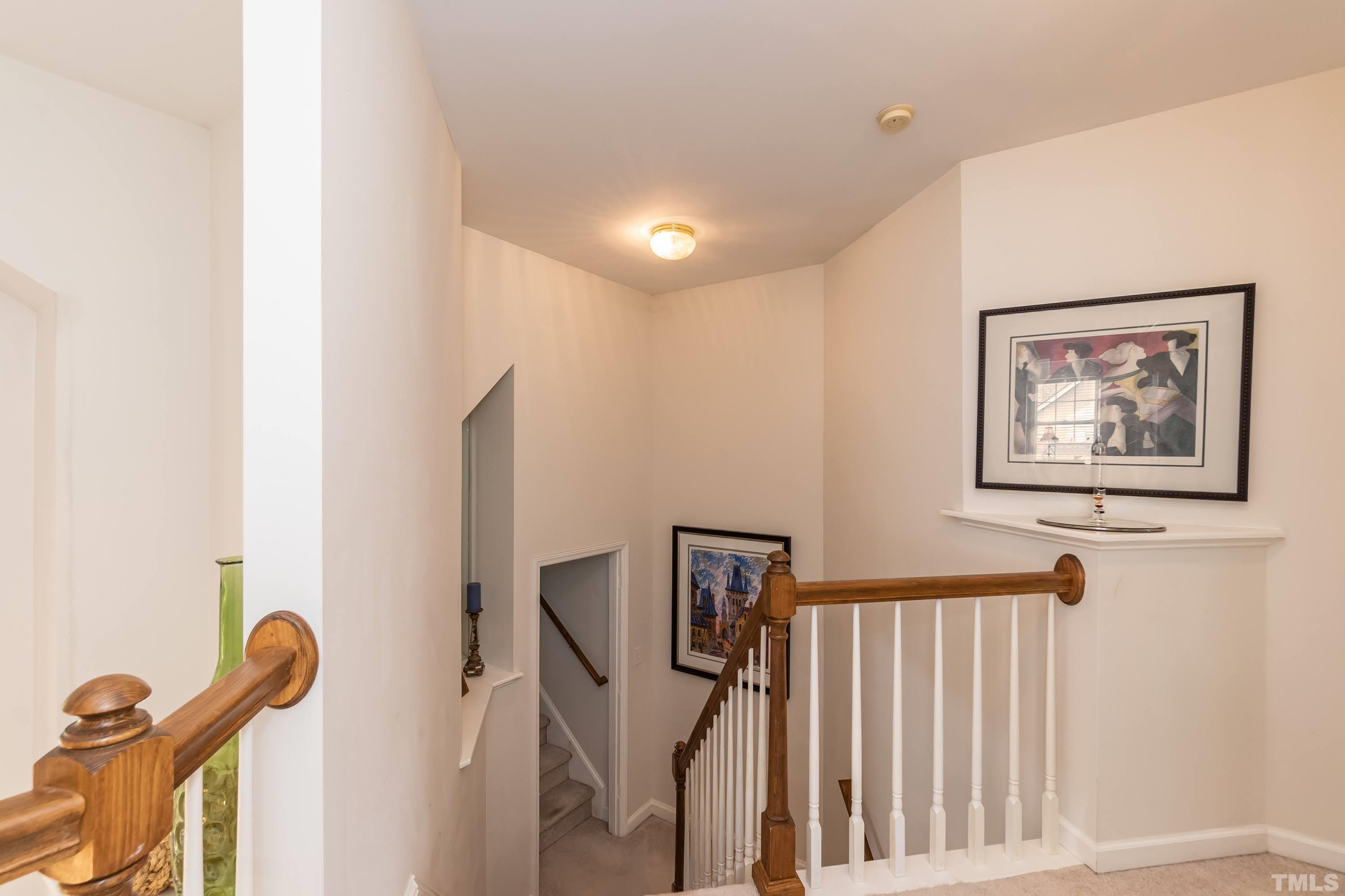 342 Seastone Street Raleigh, NC 27603 - Photo 20 of 50 a view of a hallway with paintings on the wall
