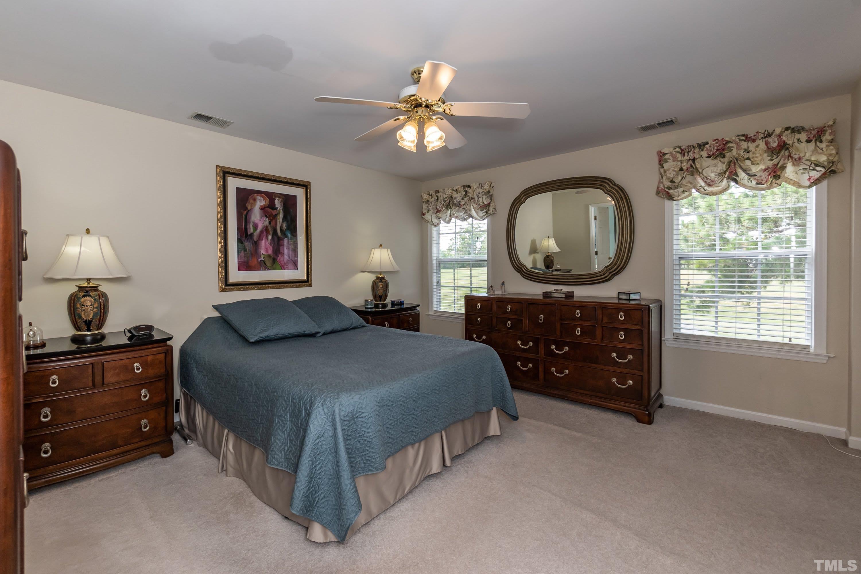 342 Seastone Street Raleigh, NC 27603 - Photo 23 of 50 a bedroom with a bed and a chandelier