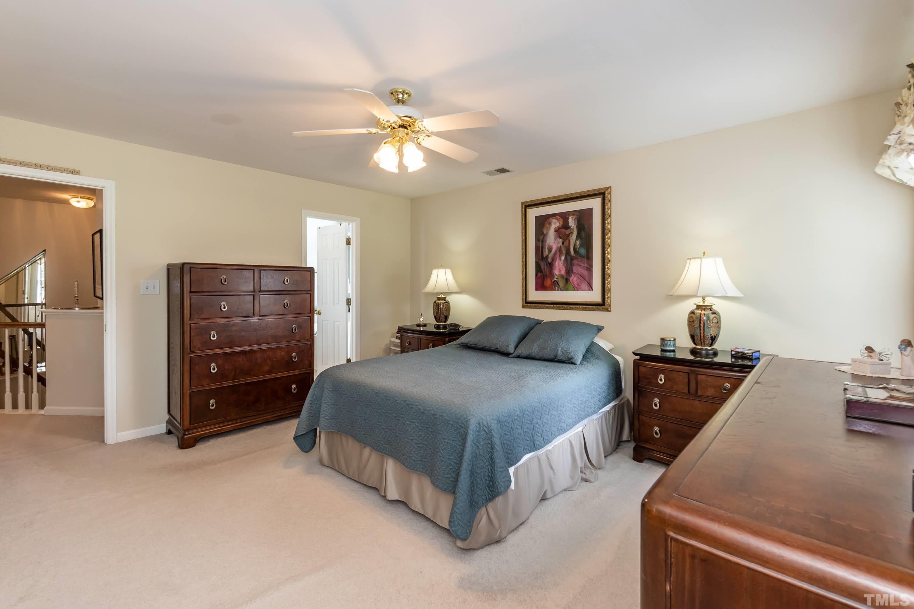 342 Seastone Street Raleigh, NC 27603 - Photo 25 of 50 a bedroom with a bed and a chandelier