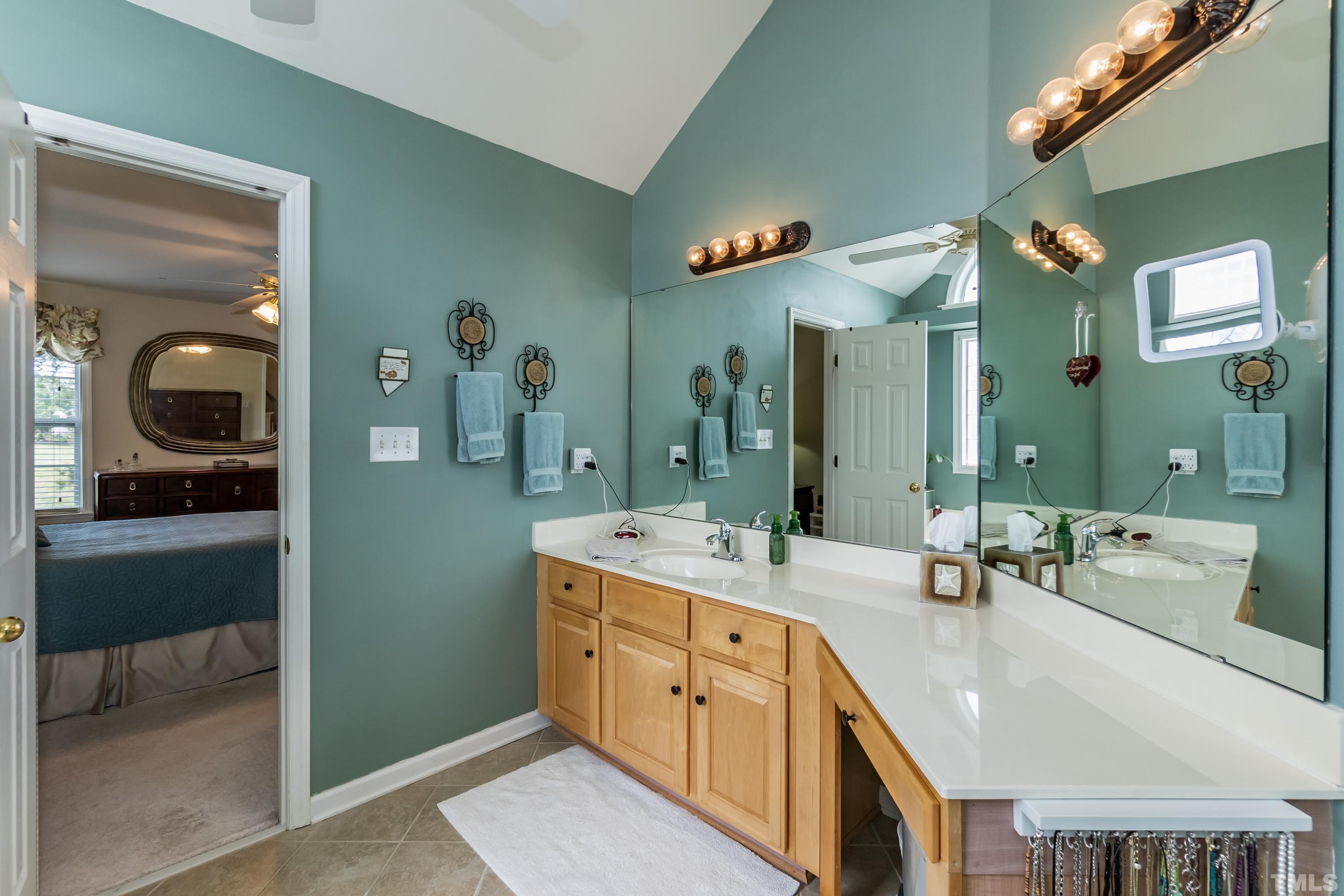 342 Seastone Street Raleigh, NC 27603 - Photo 28 of 50 a spacious bathroom with a double vanity sink and a mirror
