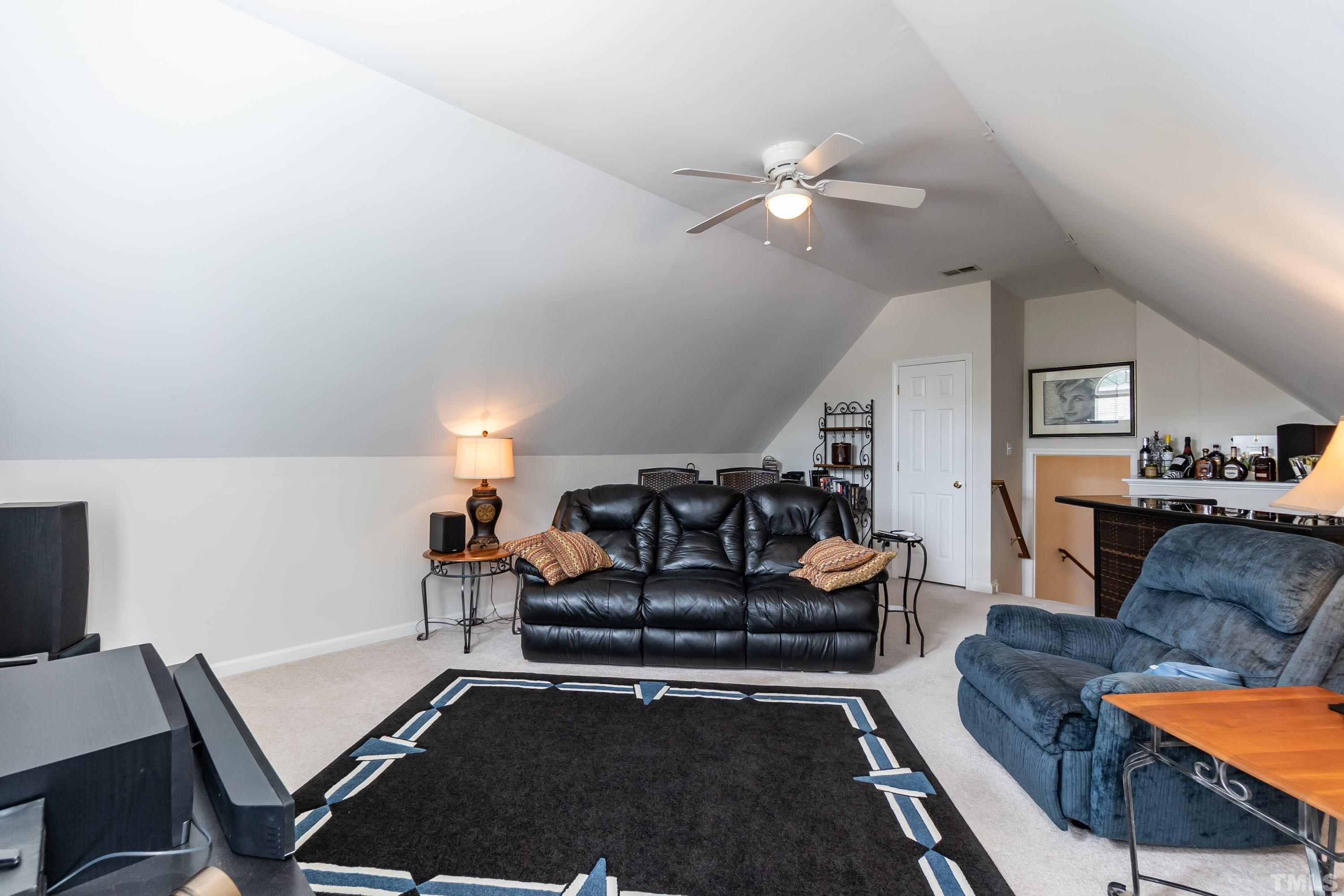342 Seastone Street Raleigh, NC 27603 - Photo 33 of 50 a living room with furniture and a chandelier