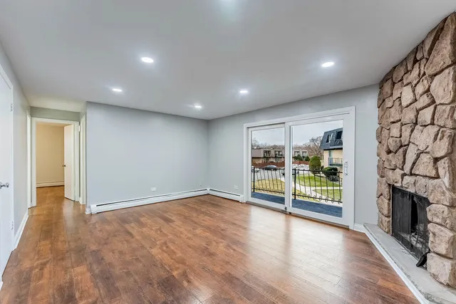 wooden floor in an empty room with a fireplace