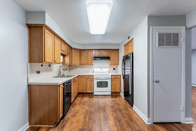 a kitchen with a sink a window and stainless steel appliances