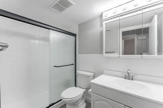 a white toilet sitting next to a bathroom sink