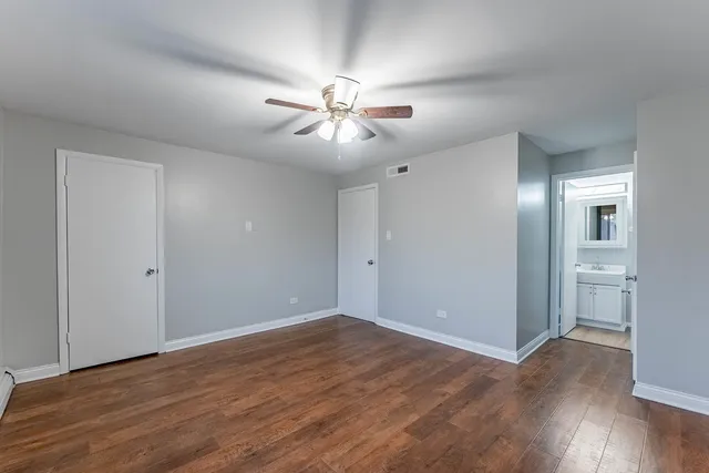 a view of empty room with wooden floor