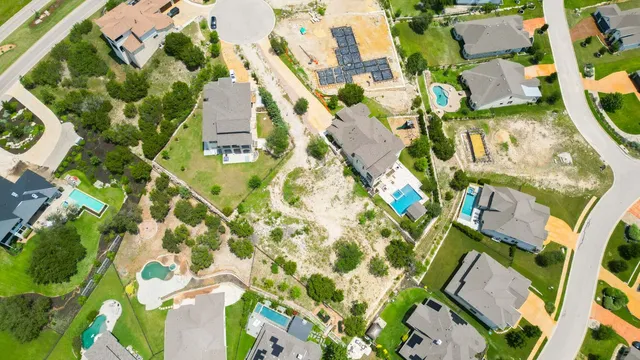 an aerial view of a house with a yard and plants
