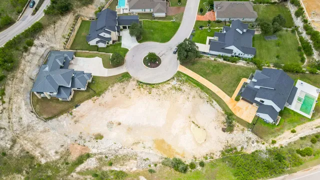 an aerial view of a house with a swimming pool and outdoor space
