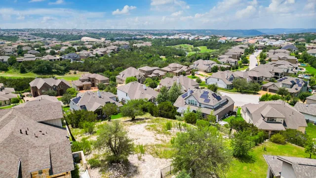 an aerial view of residential houses with outdoor space