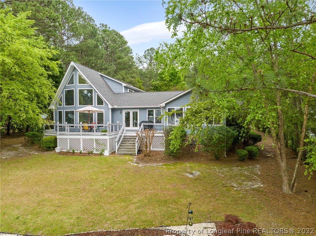 30420 East Lake Road Wagram, NC 28396 - Photo 1 of 35 a front view of a house with swimming pool
