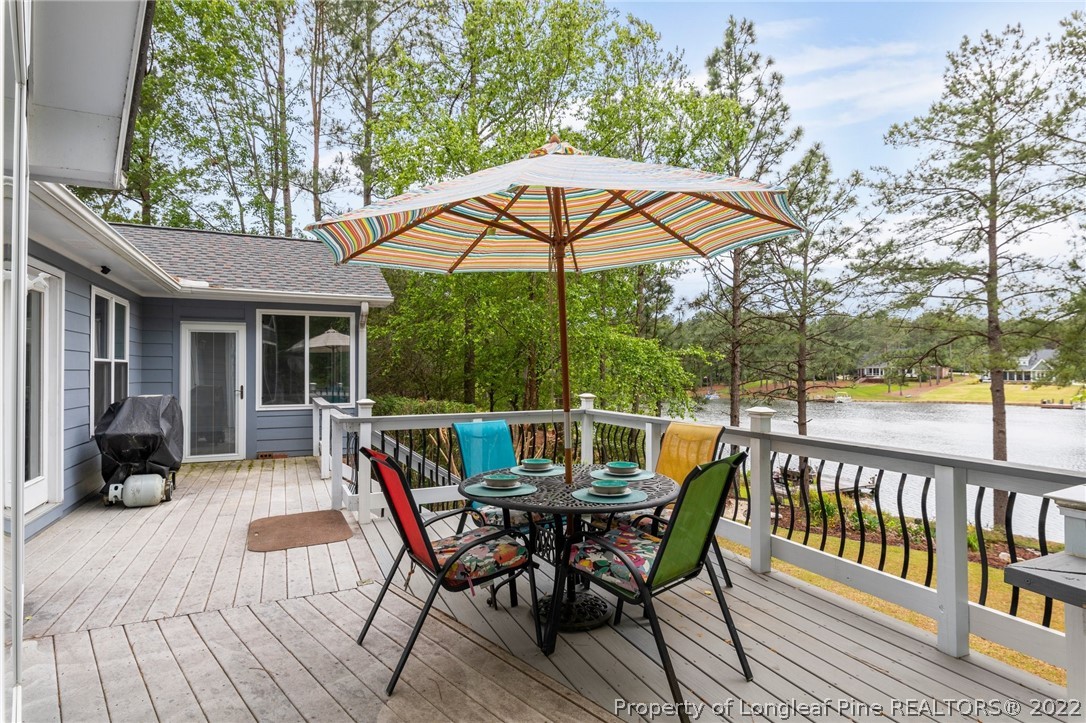 30420 East Lake Road Wagram, NC 28396 - Photo 11 of 35 a view of a two chairs and table in the deck