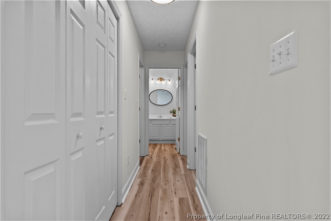 30420 East Lake Road Wagram, NC 28396 - Photo 17 of 35 a view of a hallway with wooden floor