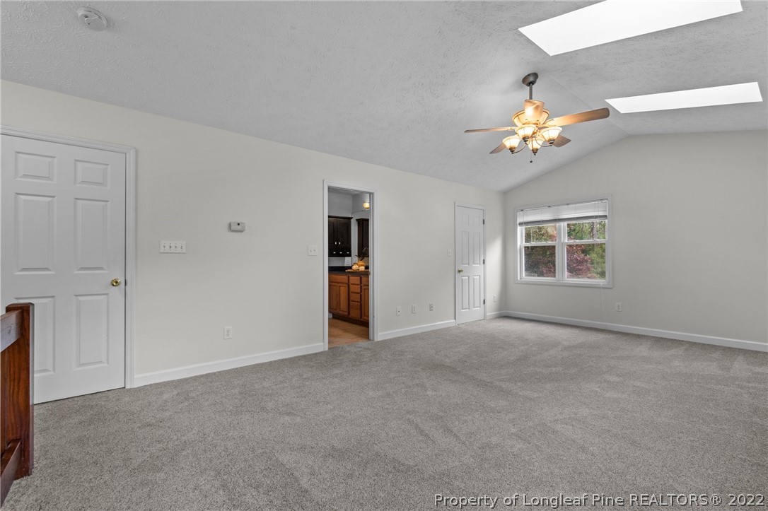 30420 East Lake Road Wagram, NC 28396 - Photo 31 of 35 a view of an empty room with a chandelier fan