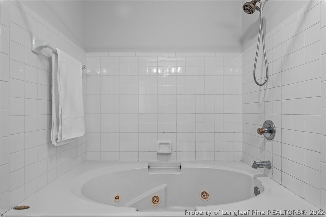 30420 East Lake Road Wagram, NC 28396 - Photo 34 of 35 a bathroom with a tub and a shower