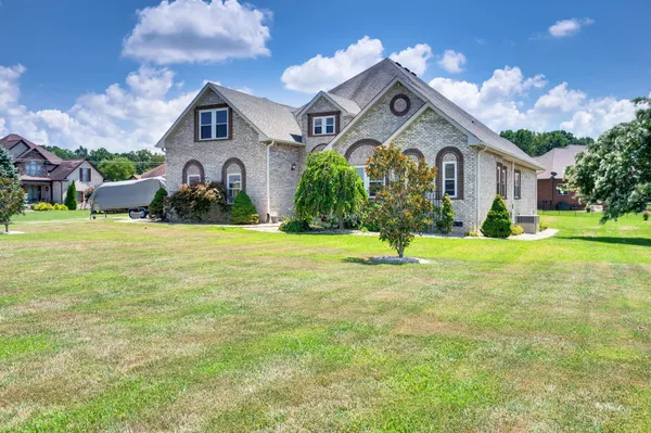 a front view of a house with a yard and garage