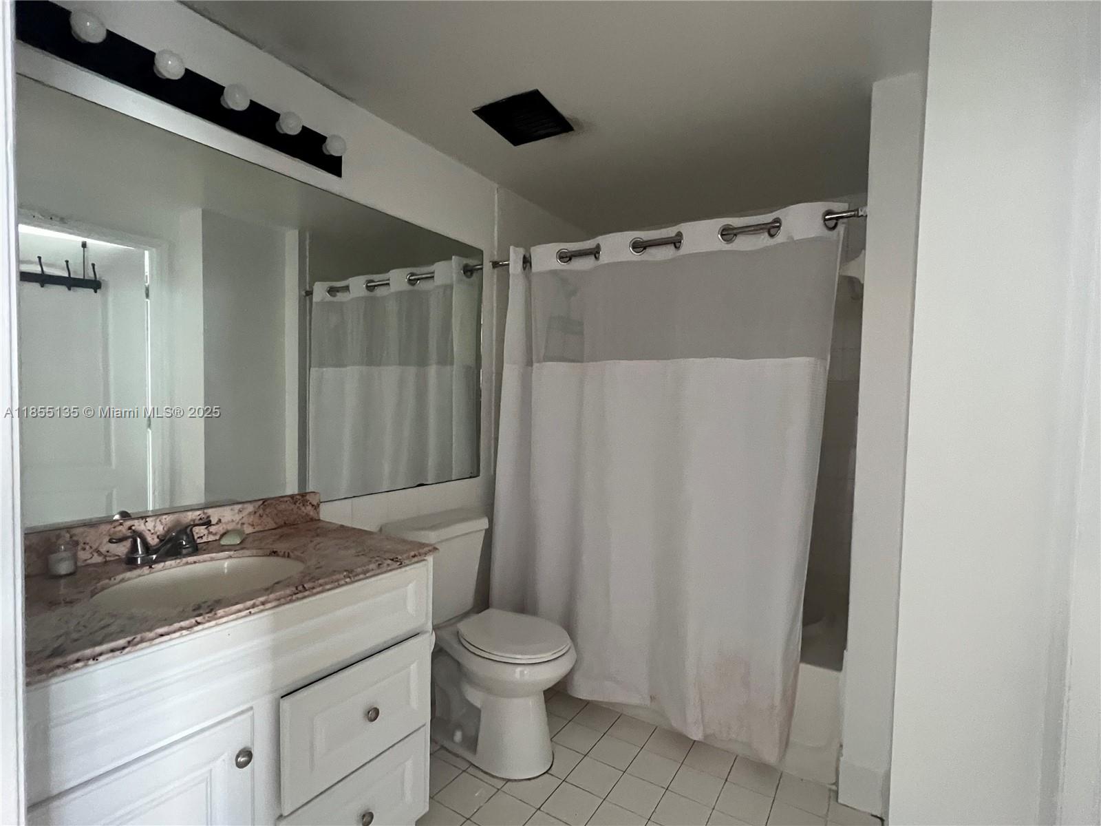 5077 Northwest 7th Street, Unit PH4 Miami, FL 33126 - Photo 9 of 25 a bathroom with a granite countertop sink toilet and shower