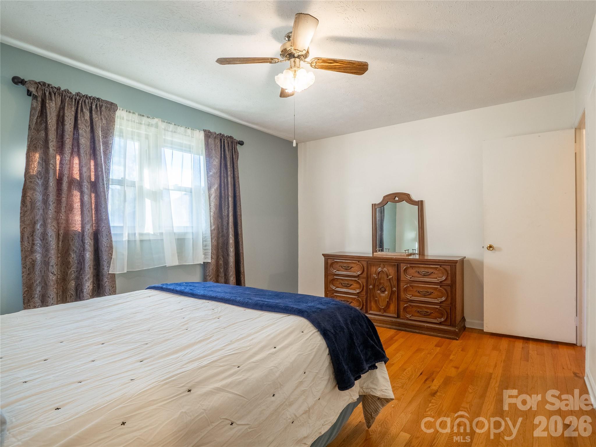 203 Oak Grove Road East Flat Rock, NC 28726 - Photo 14 of 24 a bedroom with a bed dresser and a window