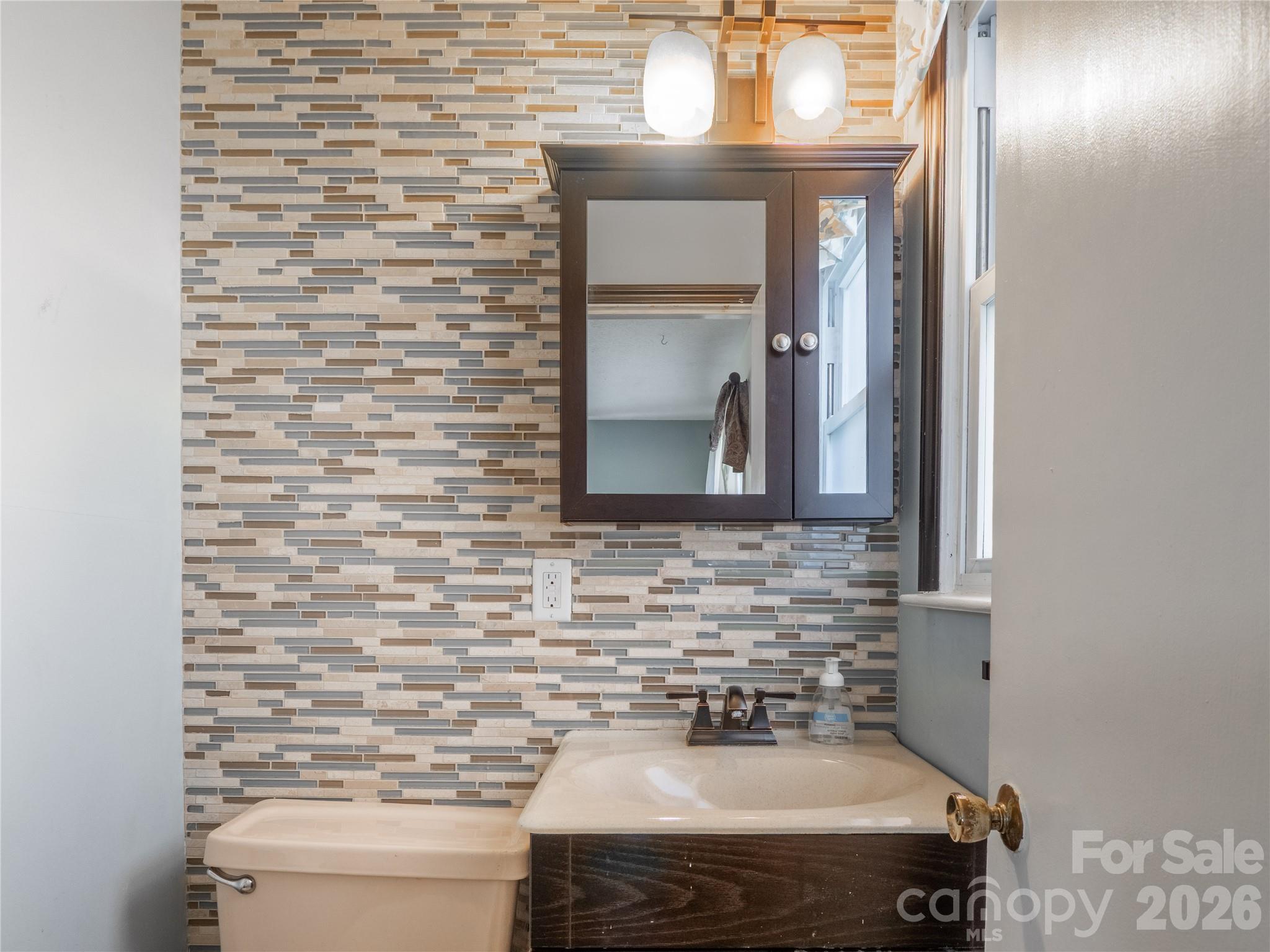 203 Oak Grove Road East Flat Rock, NC 28726 - Photo 16 of 24 a bathroom with a sink and a mirror