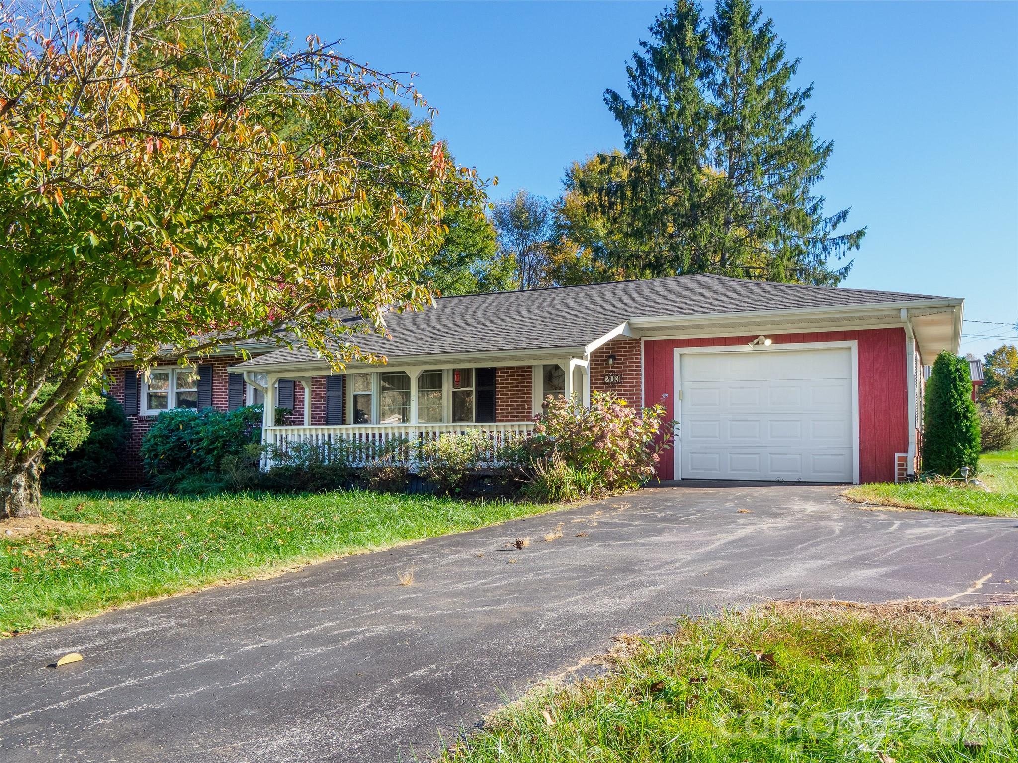 203 Oak Grove Road East Flat Rock, NC 28726 - Photo 22 of 24 a front view of a house with a garden and yard