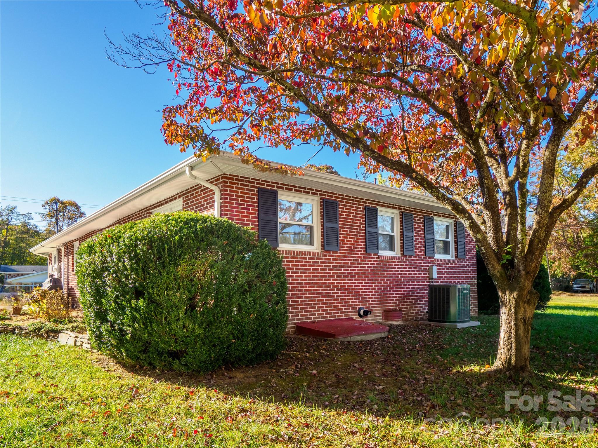 203 Oak Grove Road East Flat Rock, NC 28726 - Photo 3 of 24 a front view of a house with garden