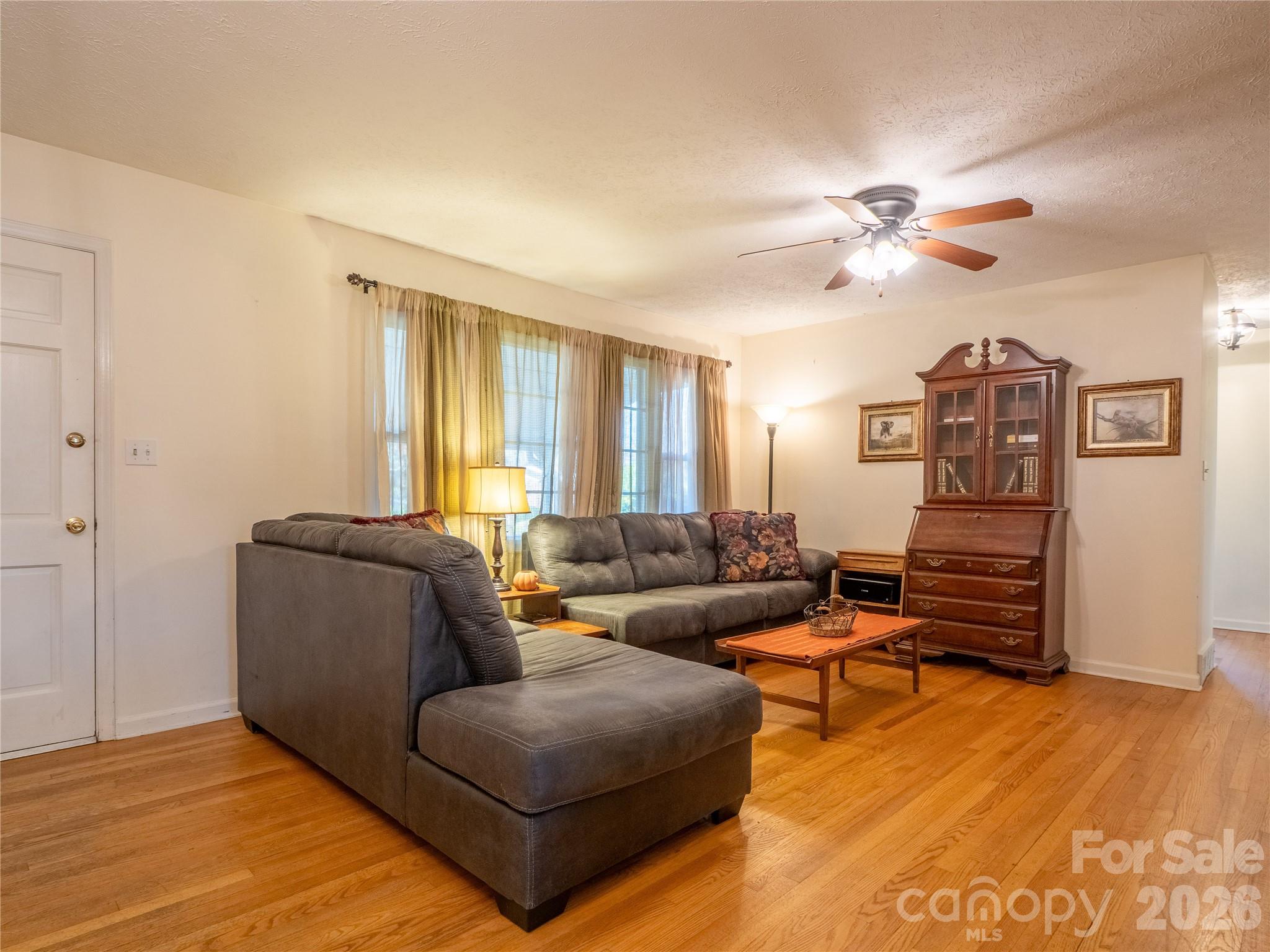 203 Oak Grove Road East Flat Rock, NC 28726 - Photo 4 of 24 a living room with furniture and wooden floor